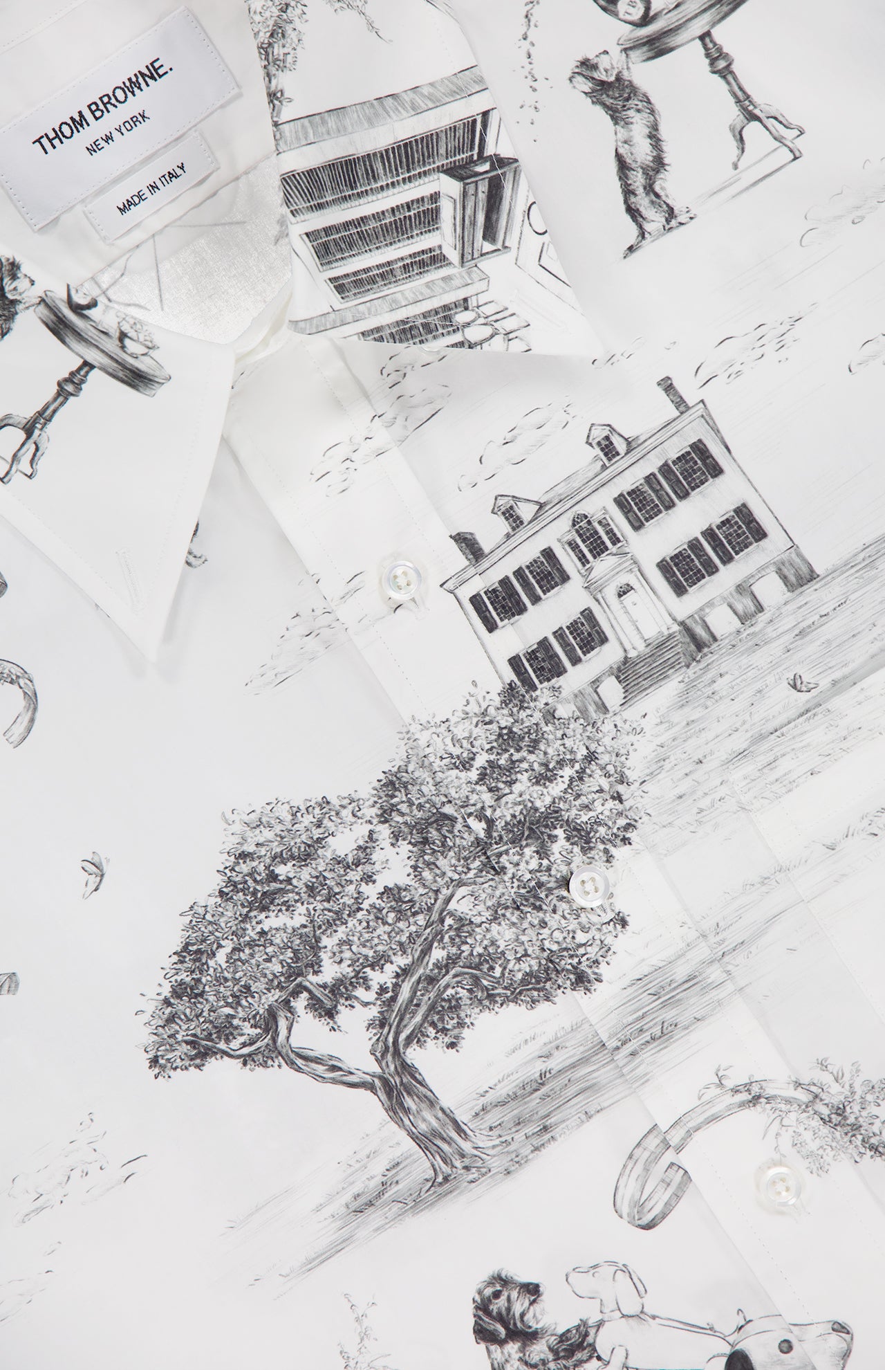 A close-up of the THOM BROWNE Hector Toile Printed Straight Fit Button Up Shirt with black line art illustrations and a visible "Thom Browne New York Made in Italy" label.