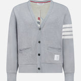 The THOM BROWNE Stitched Boat Graphic Cardigan features a light grey V-neck design, two front pockets, a white hem label, four white stripes on one sleeve, and adds coastal charm to any look.