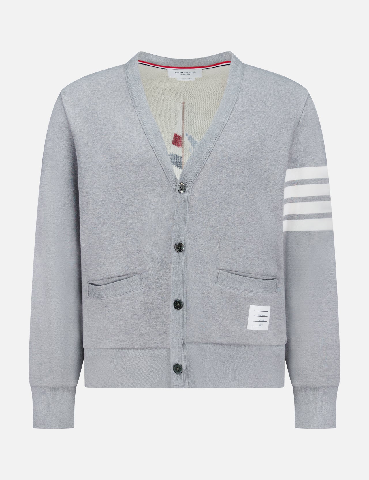 The THOM BROWNE Stitched Boat Graphic Cardigan features a light grey V-neck design, two front pockets, a white hem label, four white stripes on one sleeve, and adds coastal charm to any look.