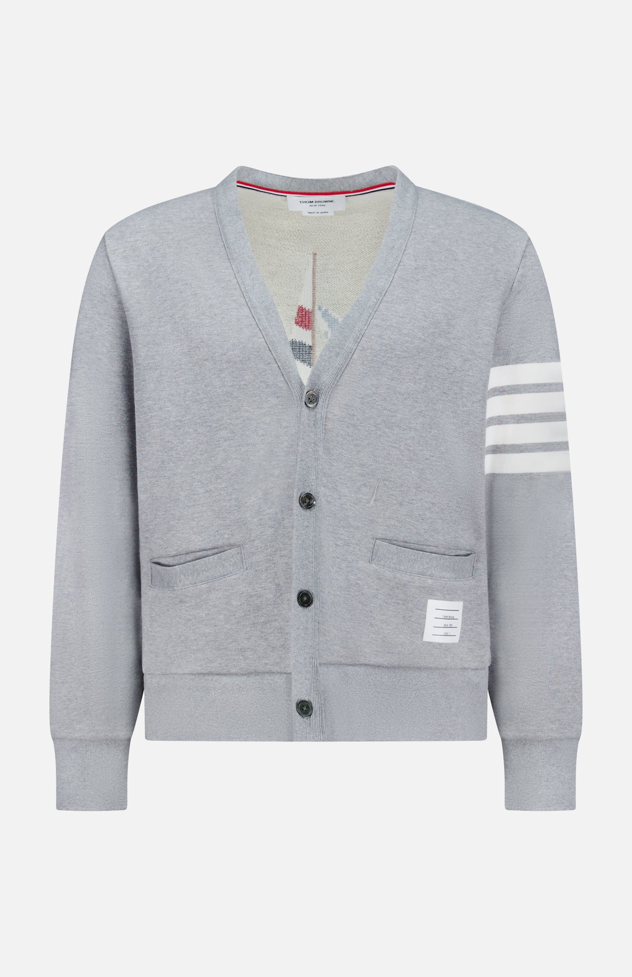 The THOM BROWNE Stitched Boat Graphic Cardigan features a light grey V-neck design, two front pockets, a white hem label, four white stripes on one sleeve, and adds coastal charm to any look.