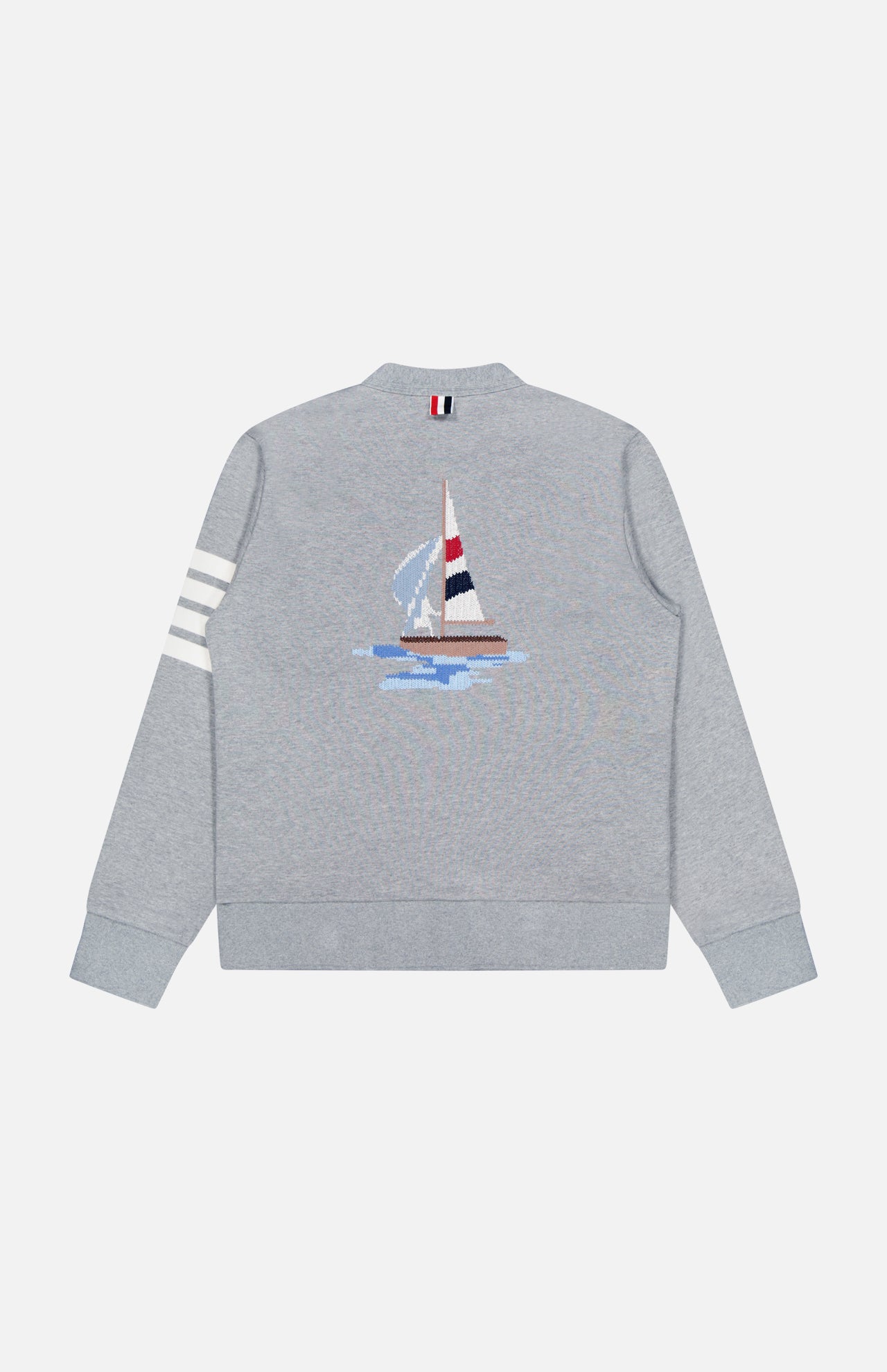 The THOM BROWNE Stitched Boat Graphic Cardigan is a light gray coastal sweater featuring white stripes on one sleeve, an embroidered sailboat graphic on the back, and a red, white, and navy tab accent on the back collar.