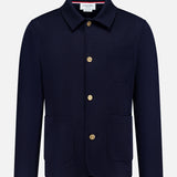 The THOM BROWNE Compact Milano Car Jacket features a collar, long sleeves, gold buttons, and three front pockets in navy, capturing classic Americana style against a plain white background.