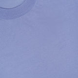 Close-up of a periwinkle blue Fine Merino Wool Classic Crewneck Pullover with a ribbed collar.