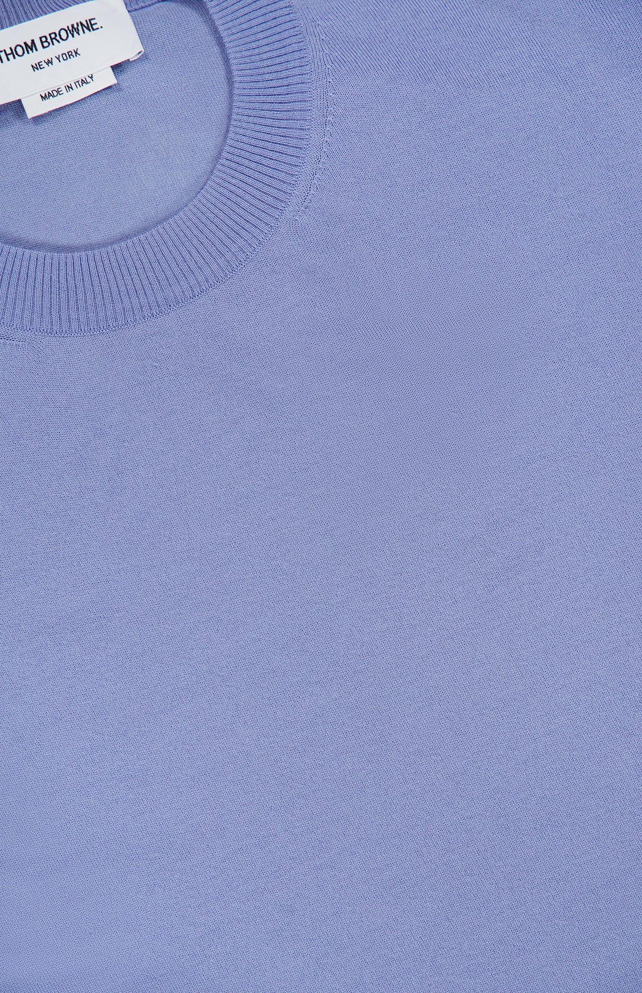 Close-up of a periwinkle blue Fine Merino Wool Classic Crewneck Pullover with a ribbed collar.