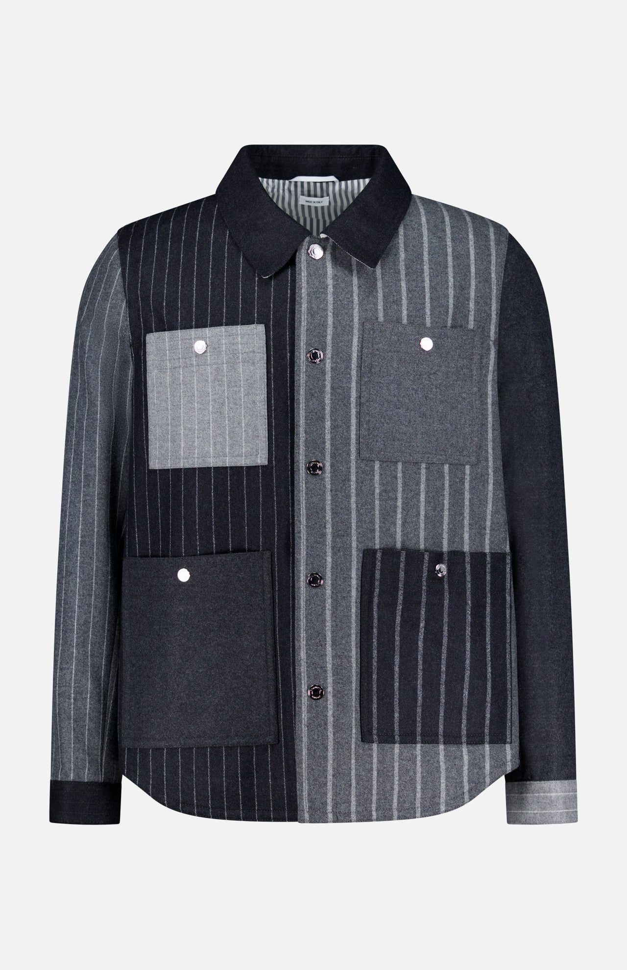 The Funmix Stripe Utility Patch Pocket Jacket by THOM BROWNE combines classic American menswear with a modern twist, featuring a long-sleeve, collared button-up design and a distinctive patchwork of vertical gray and black stripes, finished with four front utility patch pockets.