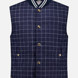 Channeling classic American sensibility, the Houndstooth Teviot Tweed Snap Front Vest by THOM BROWNE features a sleeveless navy blue houndstooth tweed design with gold snaps, two front pockets, and a ribbed collar and hem detailed with white and navy stripes.