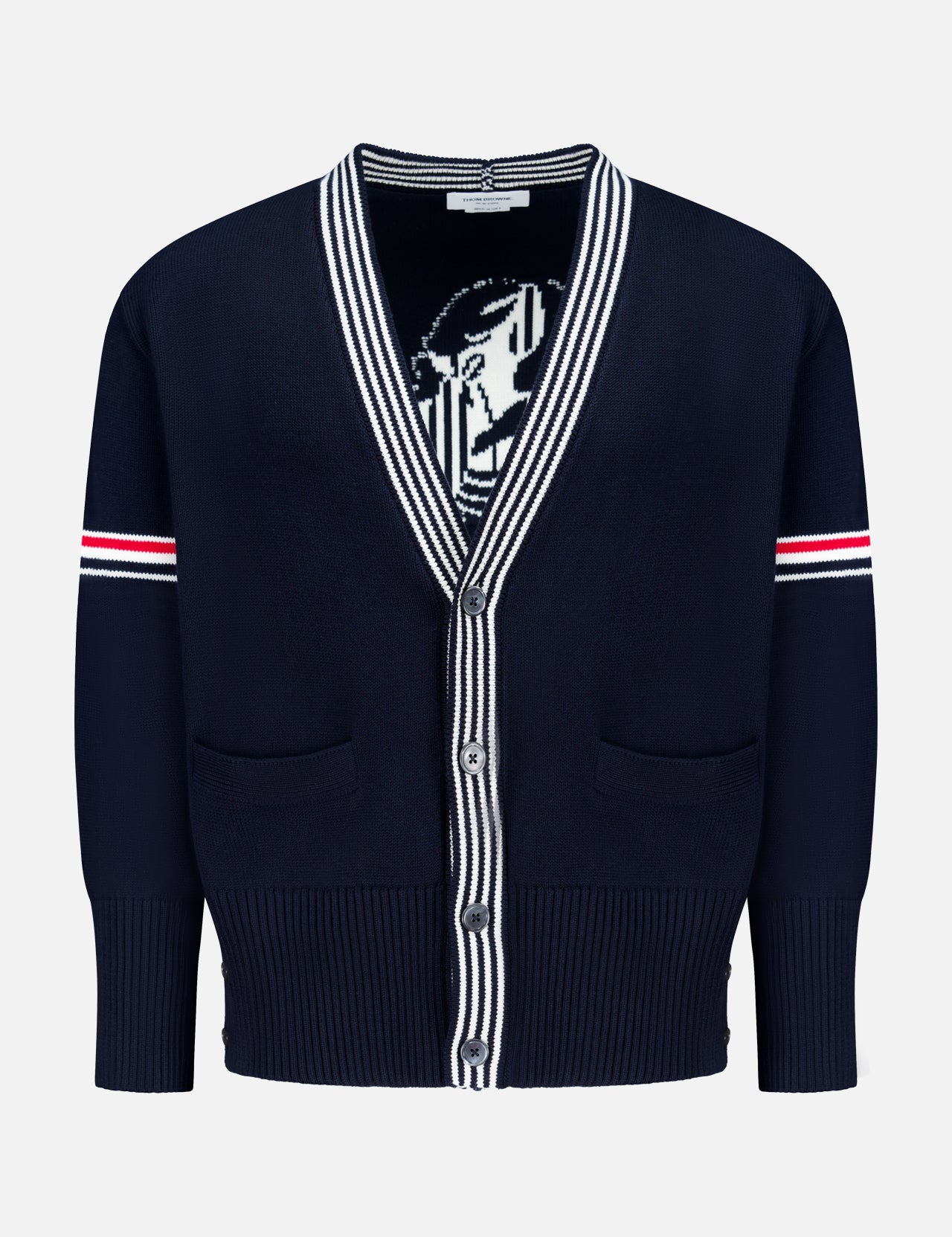 The THOM BROWNE Jersey Stitch Lobster Cardigan is a men's navy V-neck cotton cardigan with white and red striped sleeve accents, Americana-inspired striped collar and placket, two front pockets, and a partially visible lobster graphic inside.