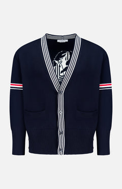 The THOM BROWNE Jersey Stitch Lobster Cardigan is a men's navy V-neck cotton cardigan with white and red striped sleeve accents, Americana-inspired striped collar and placket, two front pockets, and a partially visible lobster graphic inside.