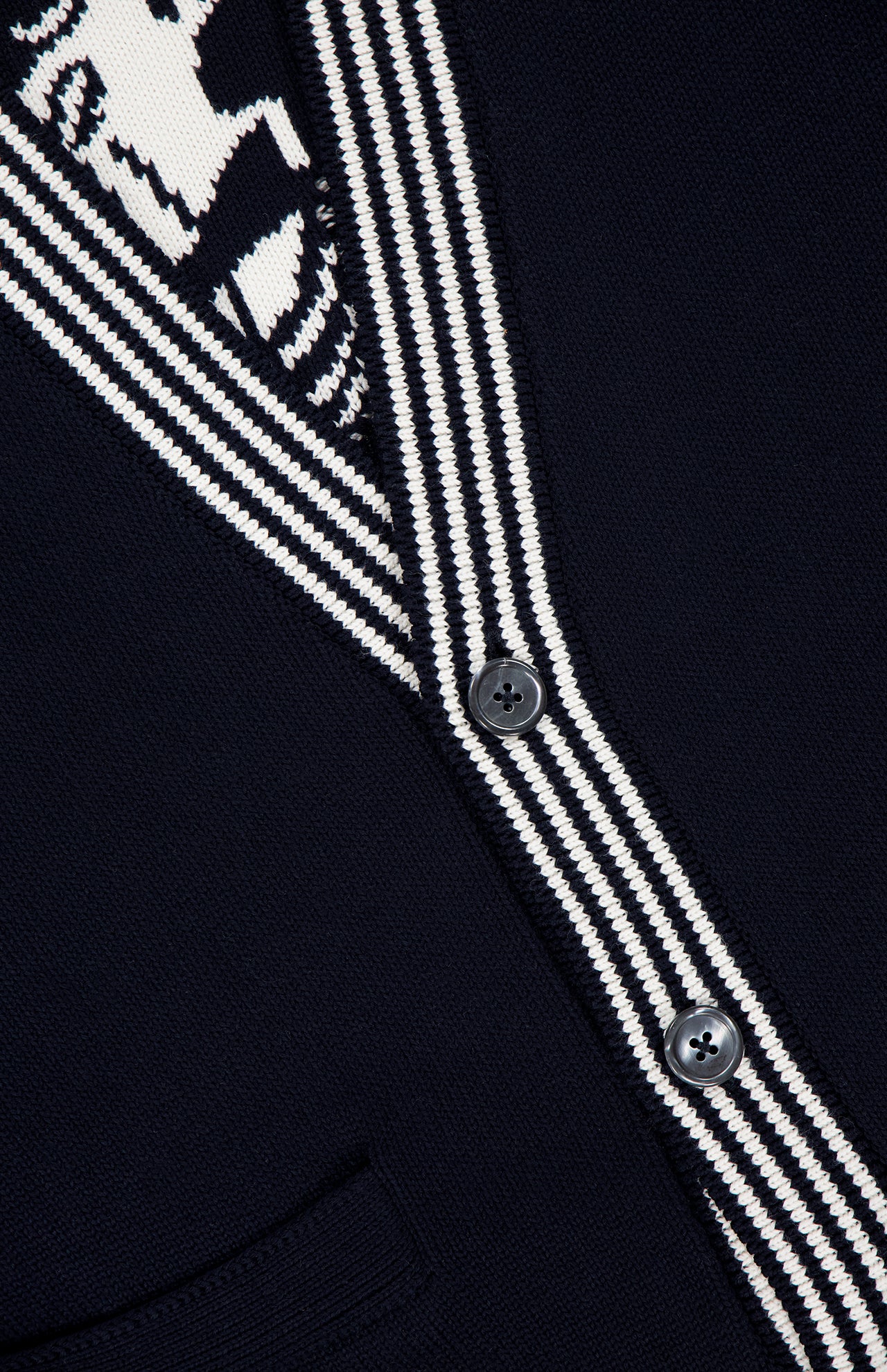 Close-up of the THOM BROWNE Jersey Stitch Lobster Cardigan for men, featuring a dark navy V-neck, black and white striped trim, two black buttons, partial white graphic at the top left, and a small pocket at the bottom.