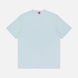 The THOM BROWNE Milano Cotton Pocket Short Sleeve T-shirt is shown from the back in light blue, featuring a small red, white, and black striped tag at the neckline for an Americana-inspired detail.