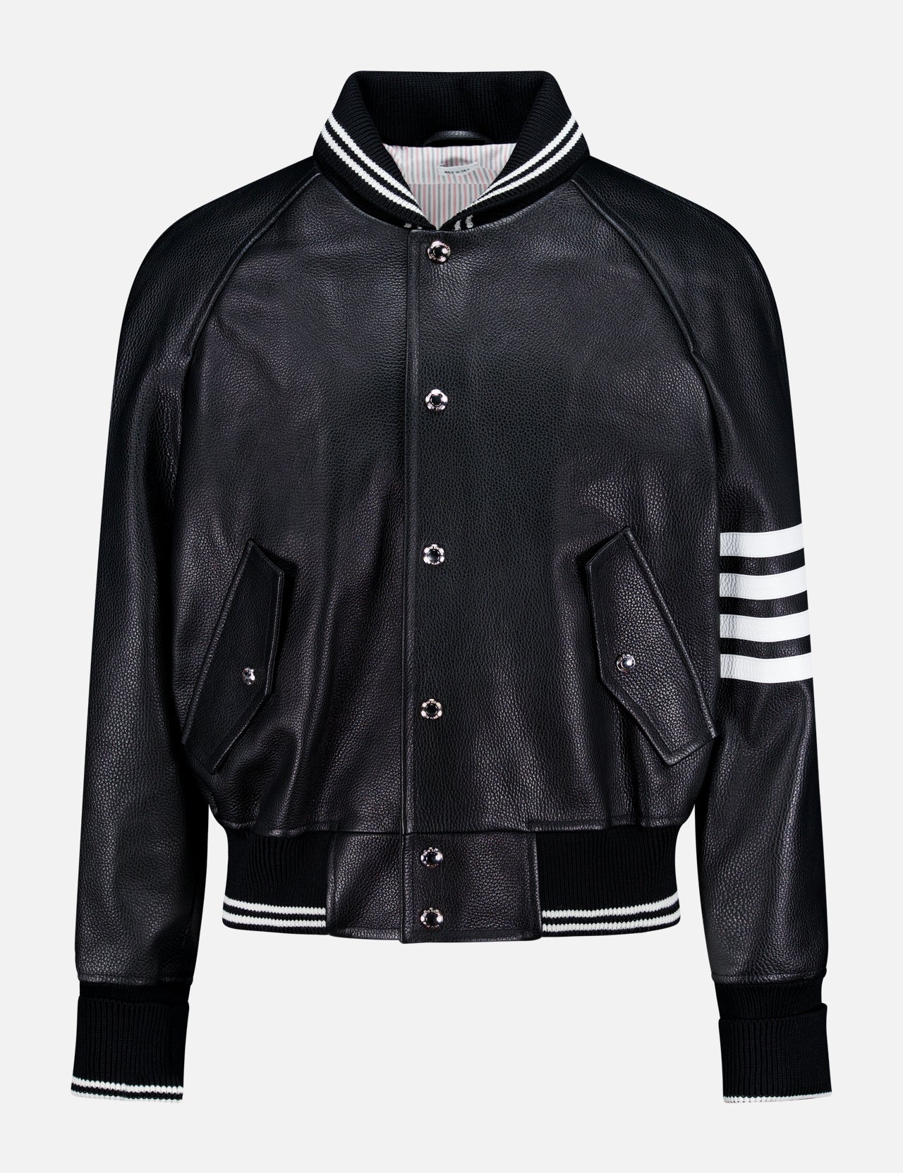 The Oversized Deerskin Leather Bomber Jacket by THOM BROWNE features black leather, white striped ribbed collar, cuffs, hem, left sleeve detail, button closures, and two angled front pockets—an Americana-inspired classic.