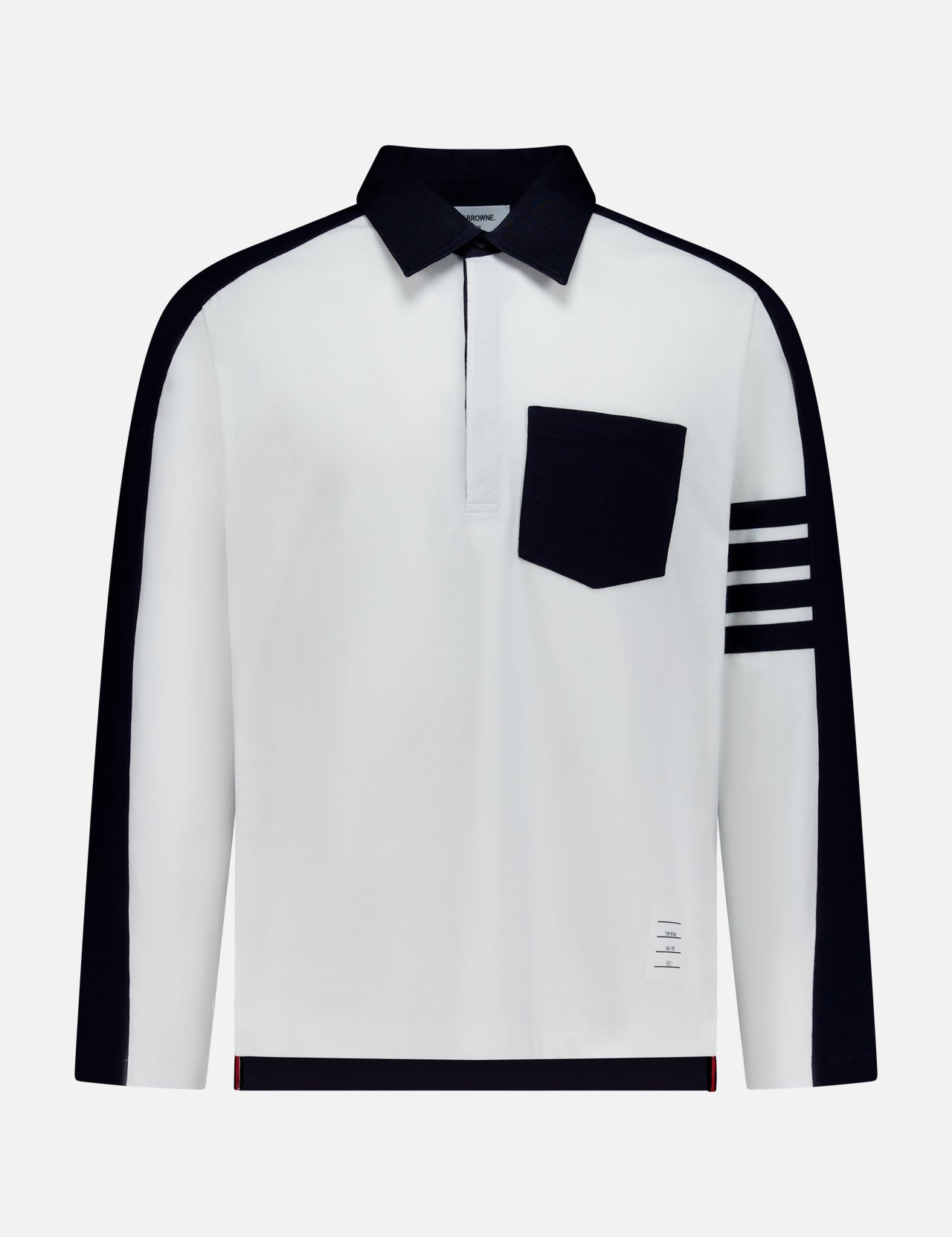 Crafted by THOM BROWNE, the Oversized Long Sleeve Colorblock Rugby Polo Shirt showcases a bold white base, accented with a contrasting black collar, distinctive black pocket, and four horizontal black stripes on the left sleeve. Black panels trace the shoulders and sleeves, lending contemporary contrast to this updated sporty essential.