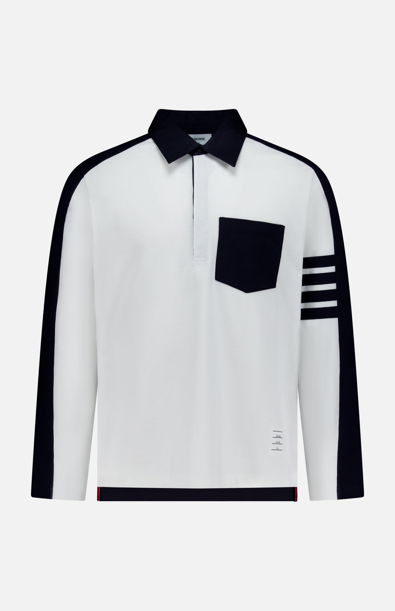 Crafted by THOM BROWNE, the Oversized Long Sleeve Colorblock Rugby Polo Shirt showcases a bold white base, accented with a contrasting black collar, distinctive black pocket, and four horizontal black stripes on the left sleeve. Black panels trace the shoulders and sleeves, lending contemporary contrast to this updated sporty essential.