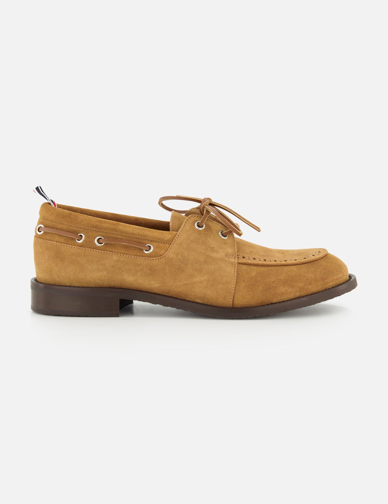 The THOM BROWNE Padded Boat Suede Loafer is a tan men's slip-on with brown laces, metal eyelets, and a low dark brown heel, shown in side profile on a white background.