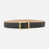 The THOM BROWNE Pebble Grain Leather Belt features black leather, a gold rectangular buckle, and a signature red, white, and blue striped detail near the buckle—a timeless men's accessory made in Italy.