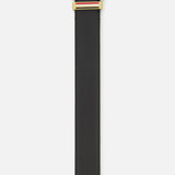 The THOM BROWNE Pebble Grain Leather Belt features black Italian leather, a gold rectangular buckle, and red, white, and blue stripes below the buckle. Displayed on a plain white background—a refined men’s accessory for any wardrobe.