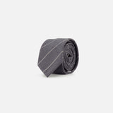 The THOM BROWNE Pinstripe Wool Classic Tie, crafted in Italy, is shown rolled up on a plain white background. This tie features a dark gray wool fabric with subtle diagonal pinstripes.