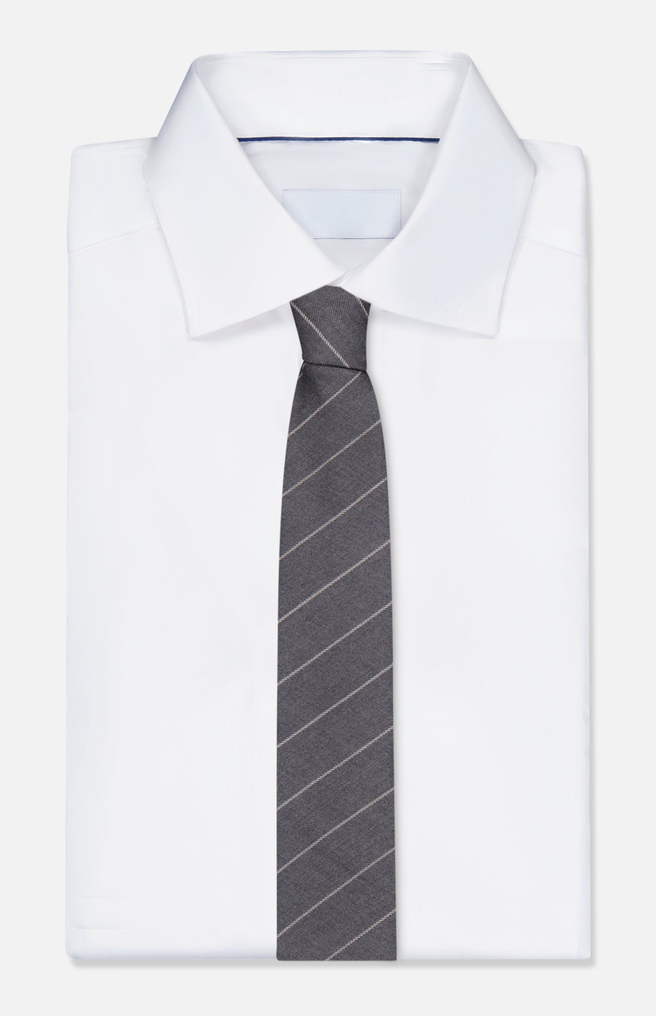 A white dress shirt is neatly folded with the THOM BROWNE Pinstripe Wool Classic Tie laid on top, set against a plain background.