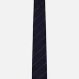 The Pinstripe Wool Classic Tie by THOM BROWNE features a dark navy blue wool fabric with subtle diagonal stripes and is crafted in Italy, shown here against a plain white background.