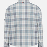 The THOM BROWNE Plaid Cotton Utility Patch Pocket Jacket features a blue, white, and gray plaid pattern in light blue. Shown from the back against a plain white background, it’s perfect as versatile men's outerwear.