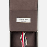 THOM BROWNE RWB Enamel Cufflinks with red, white, and blue stripes are displayed in an open dark box with a fabric interior and a THOM BROWNE. NEW YORK label.