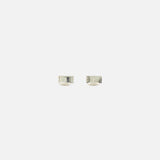 A pair of small, silver RWB Enamel Cufflinks by THOM BROWNE displayed on a plain white background evokes classic Americana style with understated elegance.
