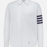 The THOM BROWNE Straight Fit 4 Bar Long Sleeve Oxford Shirt is a white shirt with a single chest pocket, four navy stripes on the left sleeve, and a signature rectangular label—blending classic Americana with modern menswear style.