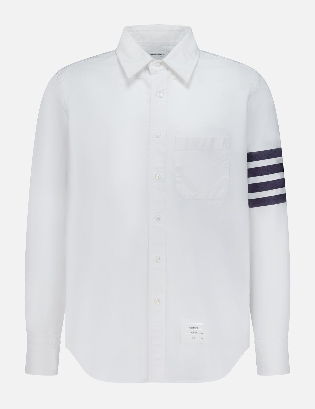 The THOM BROWNE Straight Fit 4 Bar Long Sleeve Oxford Shirt is a white shirt with a single chest pocket, four navy stripes on the left sleeve, and a signature rectangular label—blending classic Americana with modern menswear style.