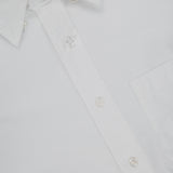 Close-up of the THOM BROWNE Straight Fit 4 Bar Long Sleeve Oxford Shirt featuring a pointed collar, front pocket, white buttons, and inner label—a classic menswear staple.