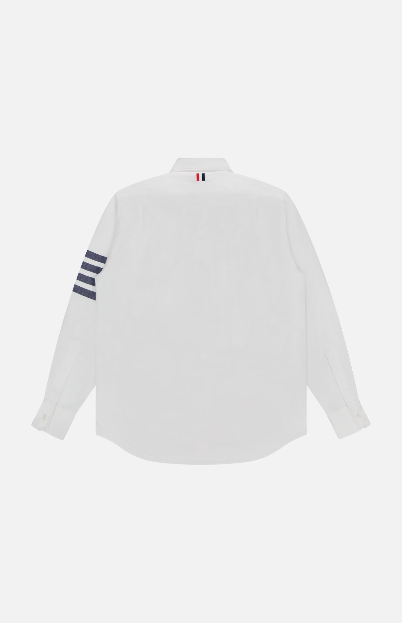 The THOM BROWNE Straight Fit 4 Bar Long Sleeve Oxford Shirt in classic white is shown from the back, featuring four navy stripes on the left sleeve and a signature red, white, and blue loop at the collar.