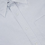 Close-up of the THOM BROWNE Straight Fit Lobsters Long Sleeve Oxford Shirt, showcasing its white fabric with thin gray vertical stripes, a pointed collar, and part of a chest pocket. The label inside the collar reads THOM BROWNE. NEW YORK. MADE IN ITALY.
