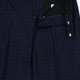 THOM BROWNE Windowpane Check Cotton Wool Trouser Pant in navy, featuring a white windowpane pattern, shown partially unbuttoned to reveal the button fly and cotton wool inner waistband.