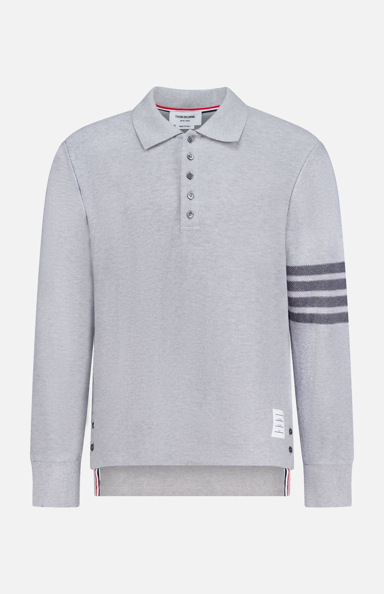 The THOM BROWNE Textured Pique Long Sleeve Polo Shirt features light grey pique cotton, a classic collar, four dark stripes on the left sleeve, side buttons, a buttoned placket, and a signature white label near the hem—a stylish choice for men.