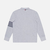 The THOM BROWNE Textured Pique Long Sleeve Polo Shirt in light grey is shown from the back, featuring four dark gray stripes on the left sleeve and a small tricolor tab at the center of the collar.
