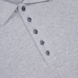 Close-up of the THOM BROWNE Textured Pique Long Sleeve Polo Shirt in light grey, featuring a collar, four dark gray buttons, and a visible brand label inside the neckline.