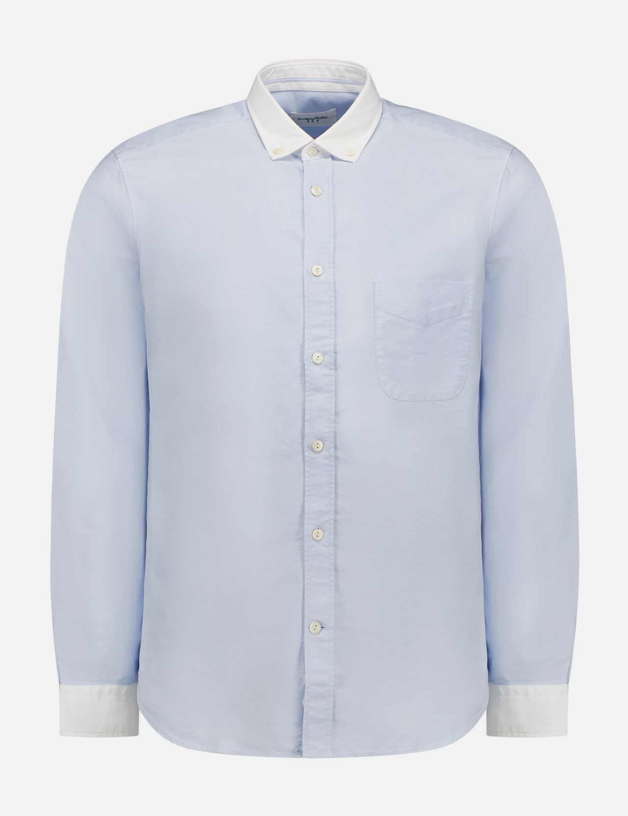 The TINTORIA MATTEI White Collar Solid Shirt features long sleeves, a light blue hue, a single chest pocket, white contrast collar and cuffs—ideal for versatile style. Displayed on a plain white background.