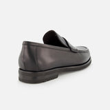 The TO BOOT Belfast Leather Loafer is pictured in black leather on a white background, angled to showcase its low heel, visible stitching, and refined Italian craftsmanship.