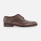 The TO BOOT Blakeley Leather Derby Oxford, a brown lace-up shoe made in Italy, is shown in side profile on a white background.
