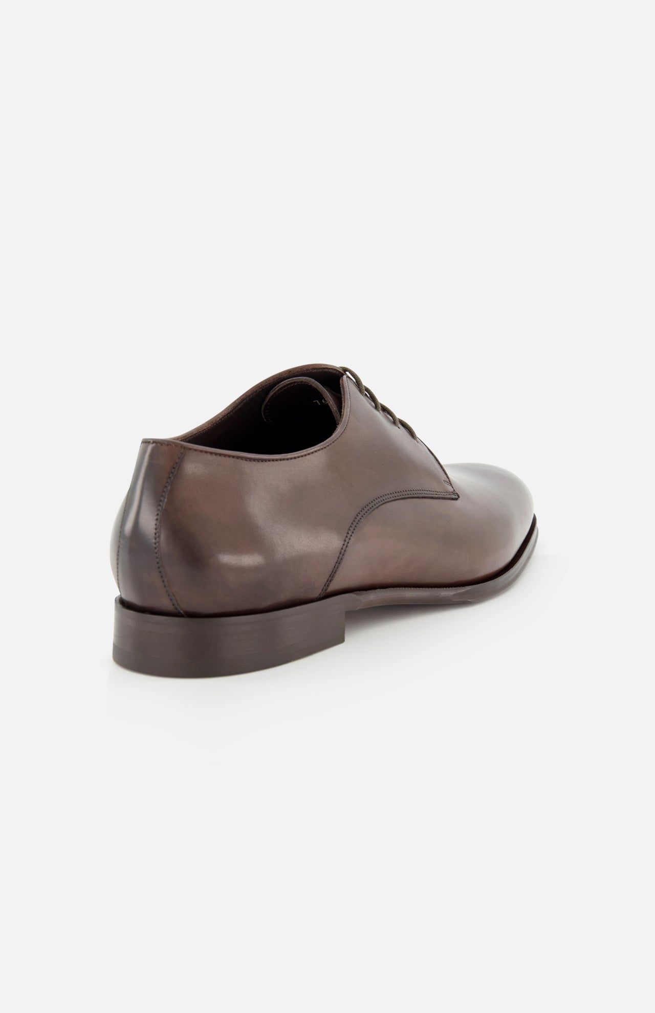 The Blakeley Leather Derby Oxford by TO BOOT is shown on a white background, angled to reveal the outer side and low stacked heel. This classic brown lace-up dress shoe features visible laces and expert Italian craftsmanship.