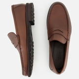 The TO BOOT Fischer Penny Leather Loafer is displayed on a white background, with one shoe shown in a side profile and the other from above. Crafted from brown leather with textured uppers, these classic slip-on loafers deliver effortless elegance for any occasion.