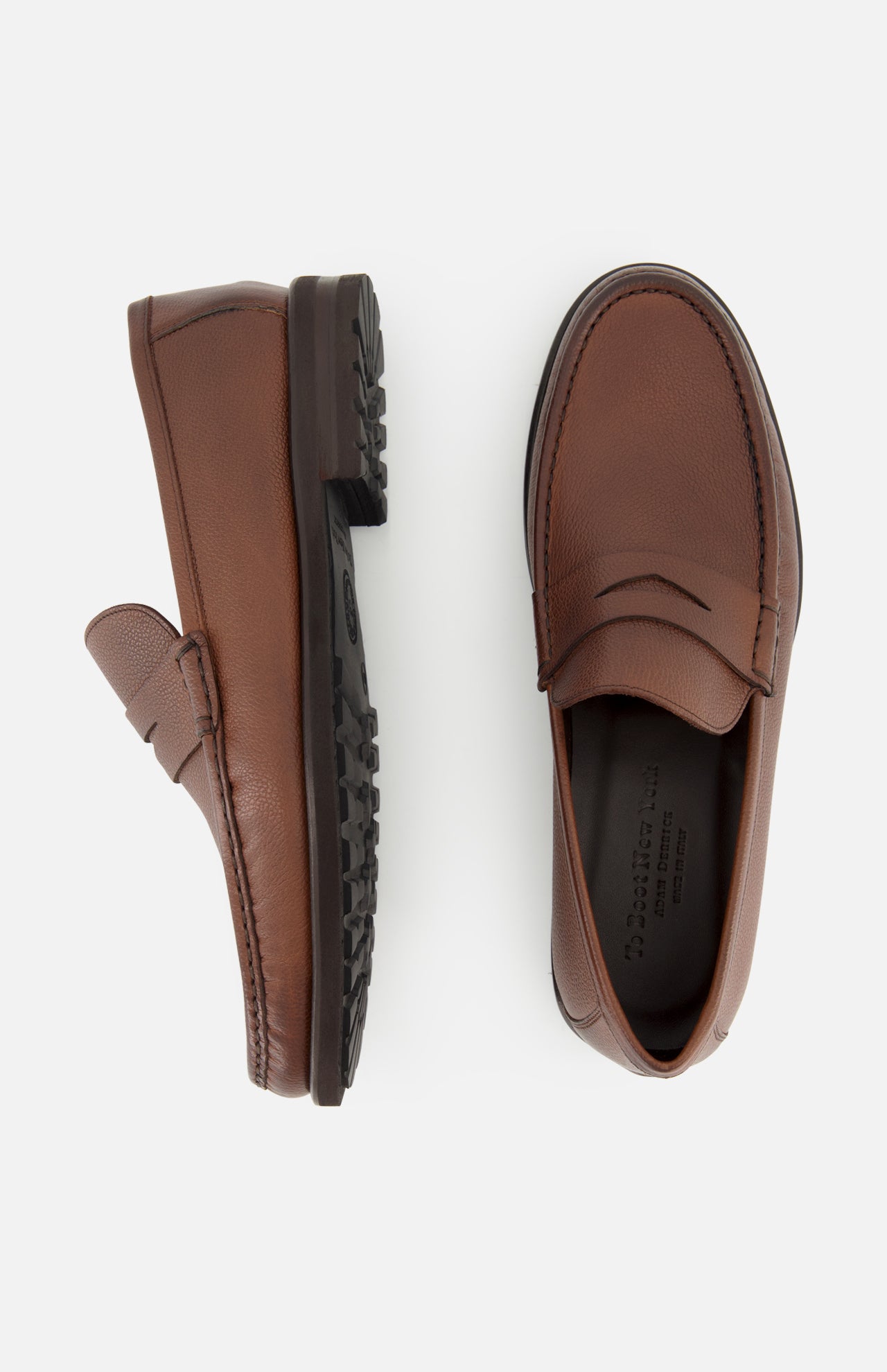 The TO BOOT Fischer Penny Leather Loafer is displayed on a white background, with one shoe shown in a side profile and the other from above. Crafted from brown leather with textured uppers, these classic slip-on loafers deliver effortless elegance for any occasion.