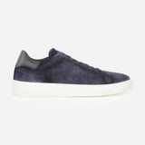 The James Slip On Sneaker by TO BOOT is a navy blue suede slip-on with a white sole and black leather heel accent, made in Italy, displayed in a side profile view on a plain white background.