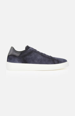 The James Slip On Sneaker by TO BOOT is a navy blue suede slip-on with a white sole and black leather heel accent, made in Italy, displayed in a side profile view on a plain white background.