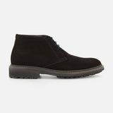 The Javier Suede Chukka Boot by TO BOOT is displayed in a side profile on a white background, featuring premium black suede, matching black laces, visible stitching, and a thick textured gray rubber sole—an essential choice for any men’s designer boot collection.