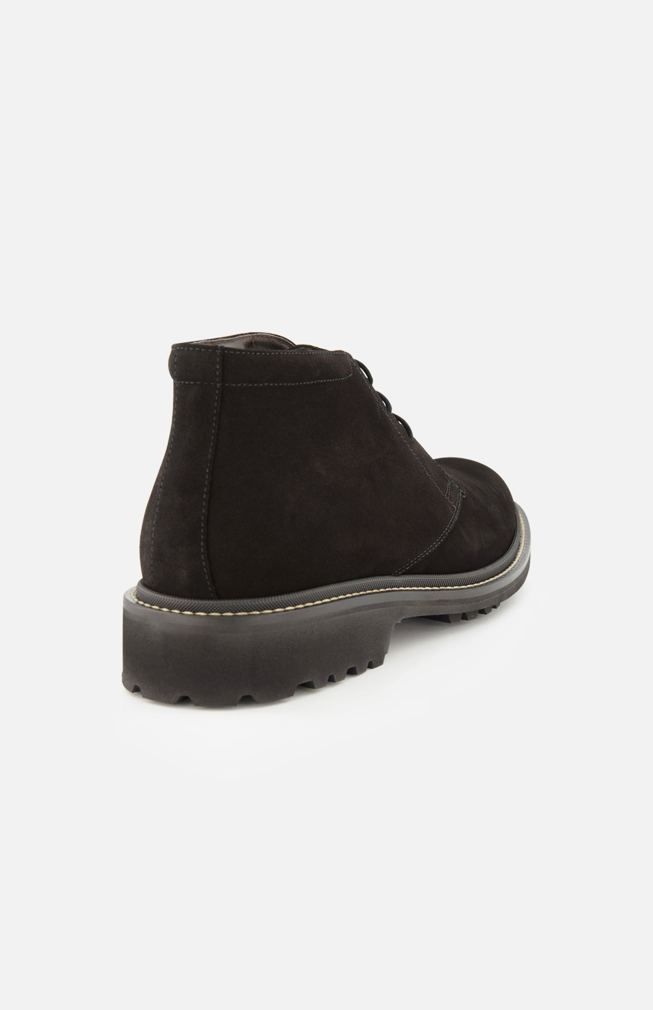 The Javier Suede Chukka Boot by TO BOOT is featured here in black suede, showcased from the back to reveal its thick, textured rubber sole and prominent edge stitching. Set against a plain white background, the refined details of these men’s designer boots stand out.