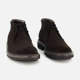 The TO BOOT Javier Suede Chukka Boot is a pair of men’s designer black suede chukka boots, featuring black laces and thick rubber soles, displayed on a plain white background.