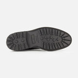 The image displays the black rubber sole of the TO BOOT Javier Suede Chukka Boot for men, seen from below, featuring a rugged tread pattern for traction and a size marking in the center.