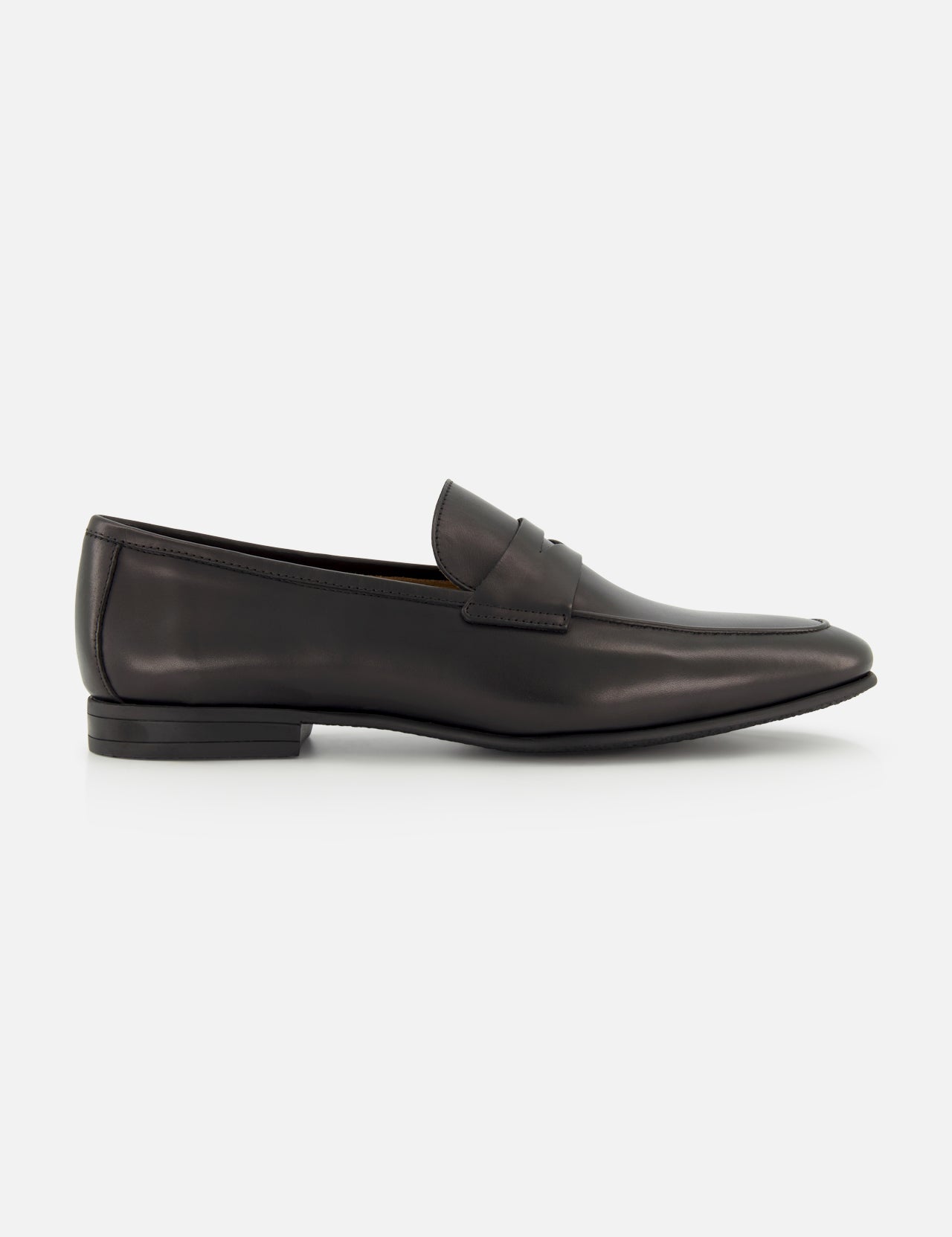 The TO BOOT Keats Leather Penny Loafer is shown in a side profile view against a white background—a single black leather loafer with a low heel and sleek, minimalist design, crafted in the classic tradition of Italian leather loafers.