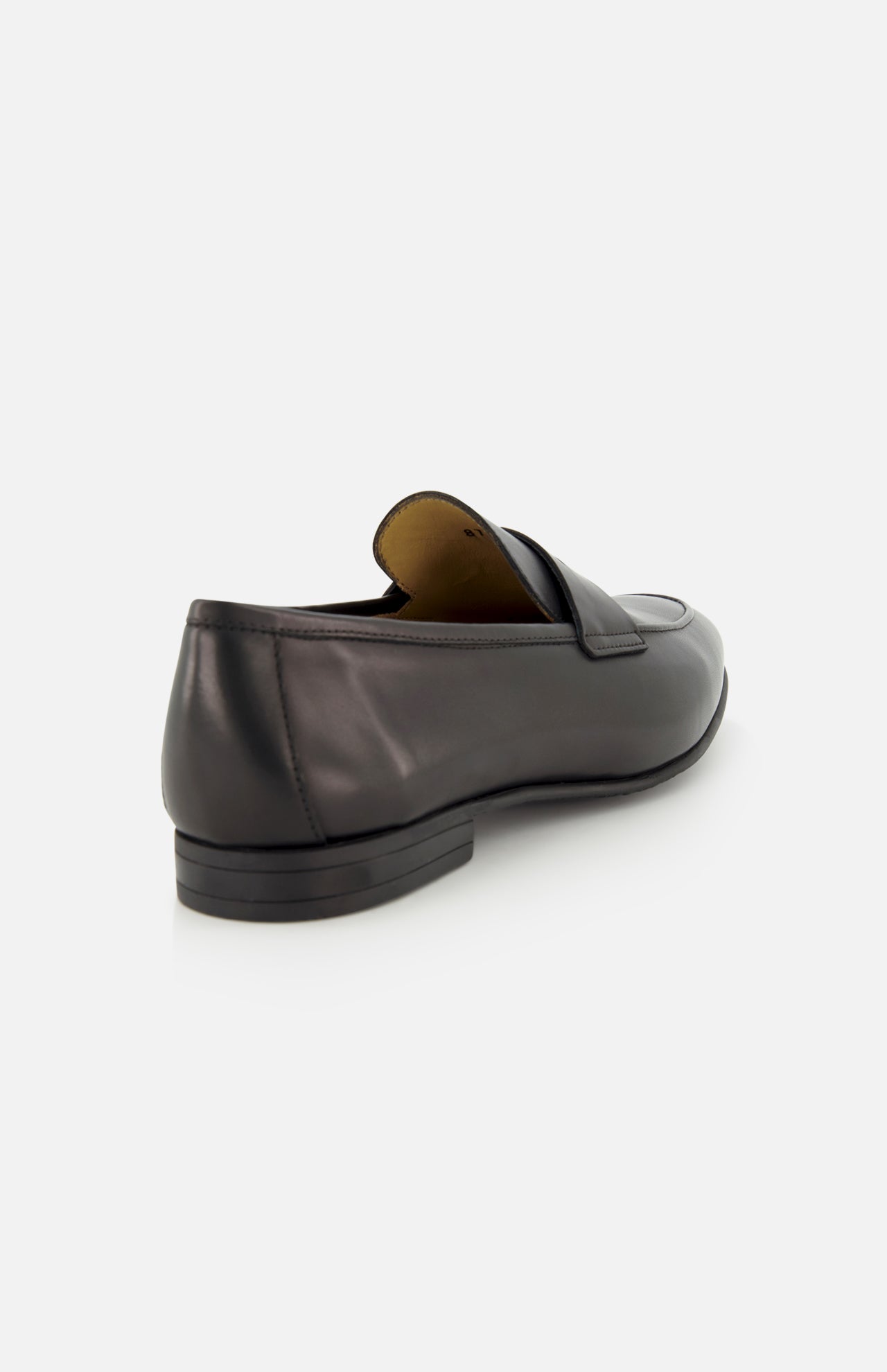 The image displays the TO BOOT Keats Leather Penny Loafer in black, shown from the back against a white background. This slip-on dress shoe features a low heel, a slightly shiny leather finish, and classic penny loafer detailing.