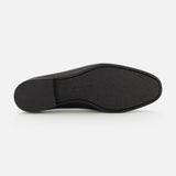 The image displays the black rubber sole of the TO BOOT Keats Leather Penny Loafer, viewed from underneath against a plain white background. The sole features a slightly textured finish and a low heel, reflecting the classic style of these leather loafers.